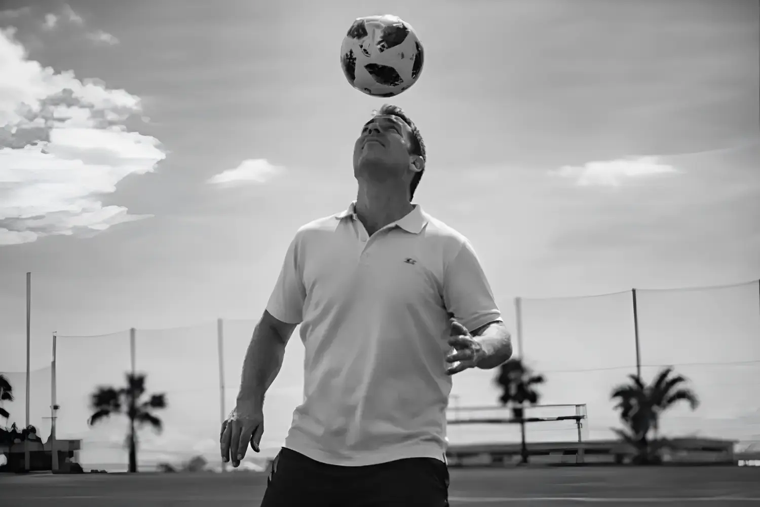 Mental performance coach Christoph Kleinbeck heading a soccer ball to demonstrate athletic focus and mindset training for elite talents.